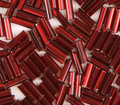 Close-up of loose 6mm Preciosa Czech glass bugle beads in silver-lined red