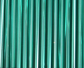 Rows of 30mm Preciosa Czech glass bugle beads in silver-lined teal