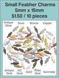 Pile of 5 x 15mm feather charms in silver, gold, bronze, copper, rose gold, gunmetal and other finishes