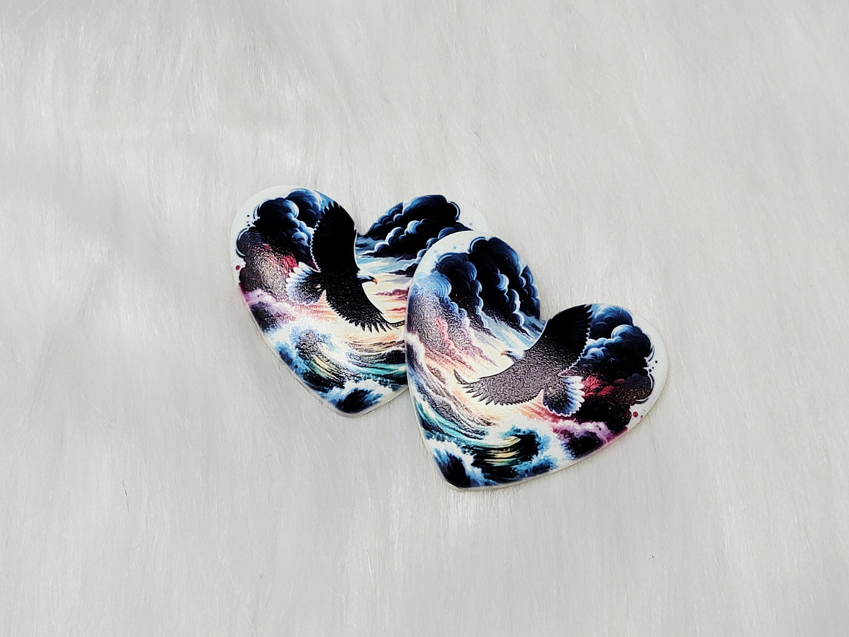 Pair of 37mm resin heart cabochons (cabs) with a soaring eagle against dark clouds and a sunset
