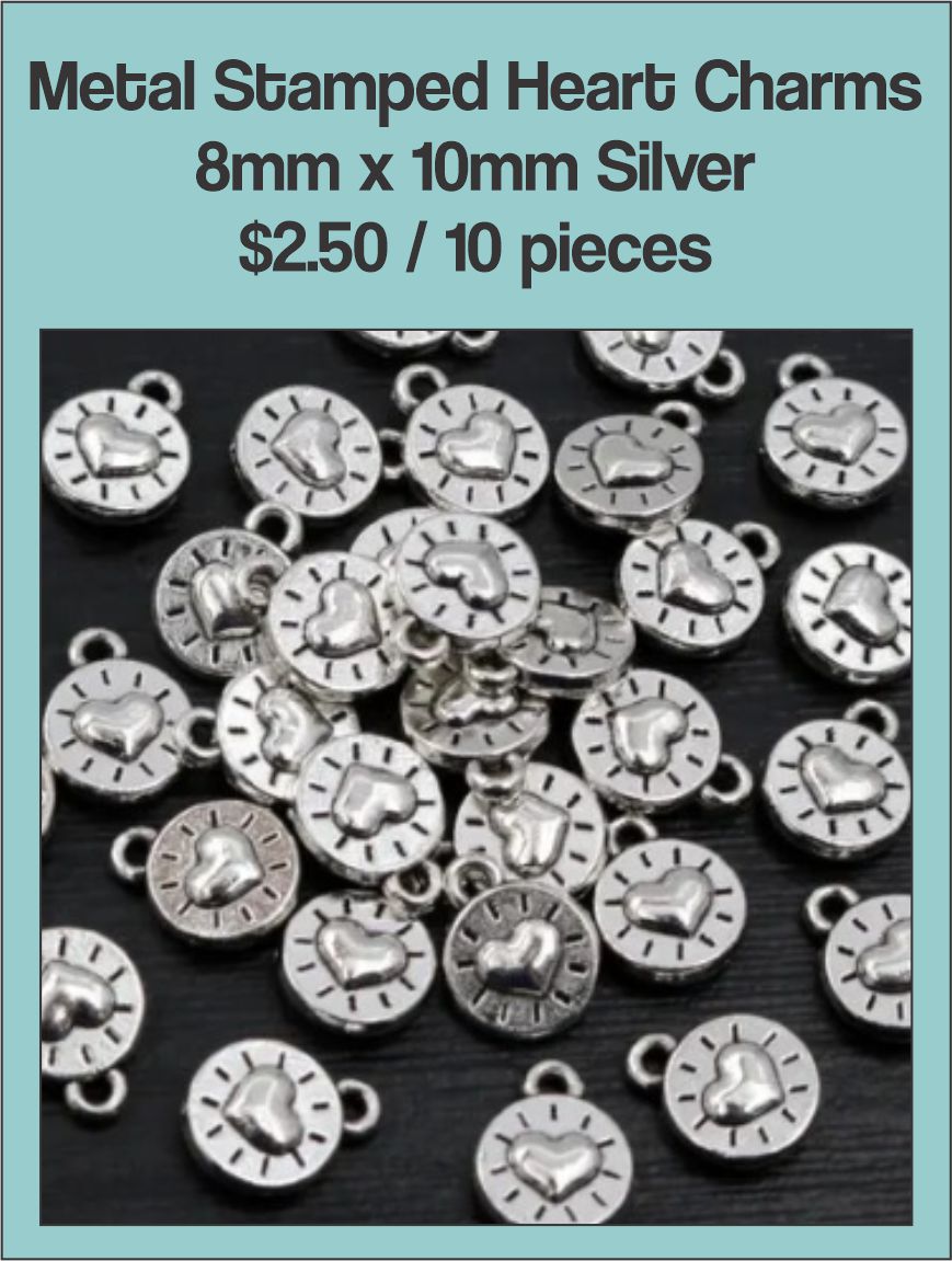 Pile of silver-tone 8 x 10mm round charms stamped with a heart