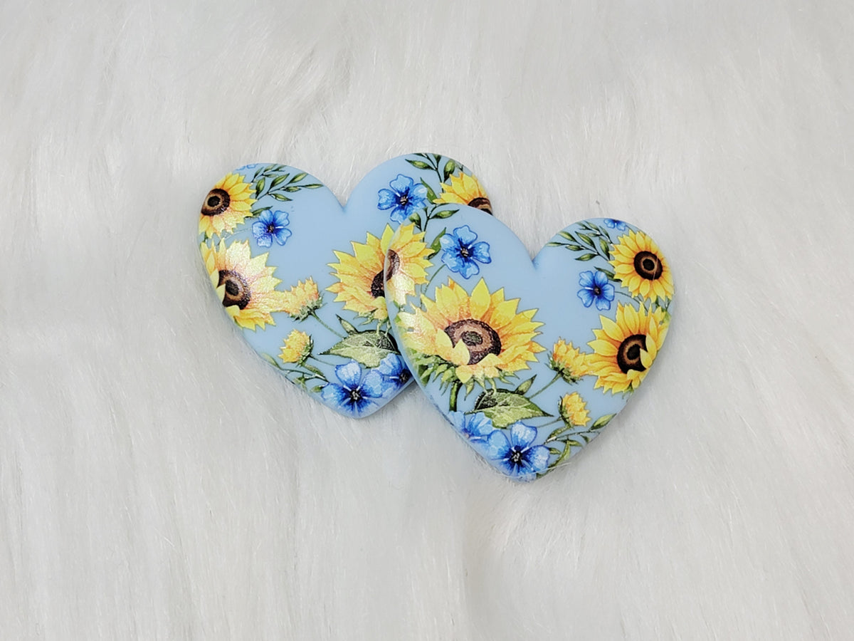 Pair of 37mm resin heart cabochons (cabs) in light blue with sunflowers and blue flowers