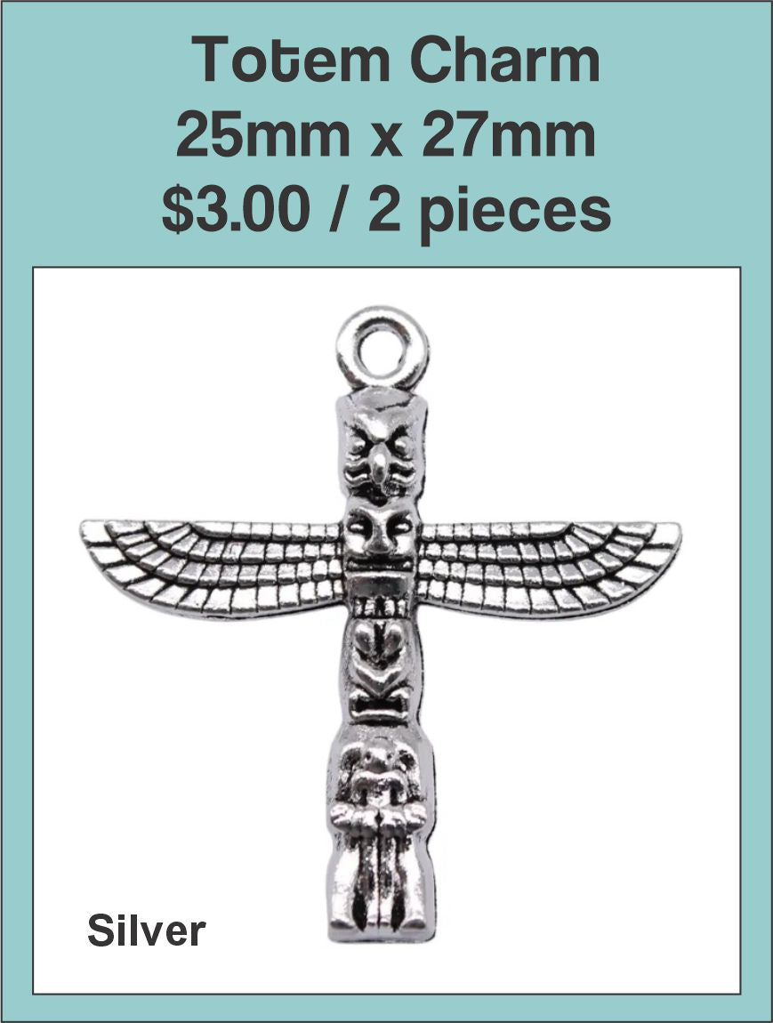 Silver-tone 25 x 27mm totem charm with outstretched wings on a labelled product card