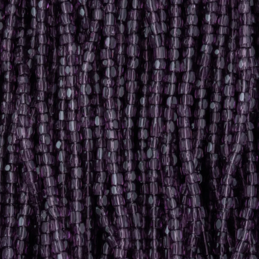 Close-up of strung Preciosa 9/0 three-cut glass seed beads in transparent amethyst