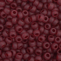 Close-up of Preciosa 11/0 Czech glass seed beads in transparent garnet matte