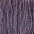 Close-up of strung Preciosa 13/0 true cut charlotte beads in transparent light amethyst with a luster finish