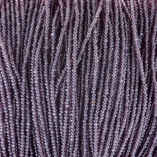 Close-up of strung Preciosa 13/0 true cut charlotte beads in transparent light amethyst with a luster finish