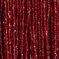 Close-up of strung Preciosa 9/0 three-cut glass seed beads in transparent ruby
