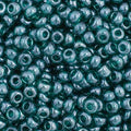 Close-up of Preciosa 11/0 Czech glass seed beads in transparent teal with a luster finish