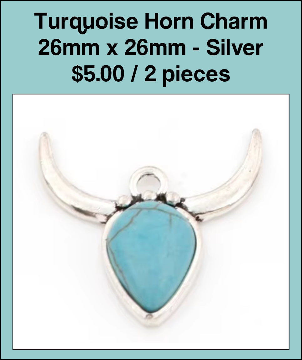 Silver-tone 26mm steer head charm with curved horns and a turquoise-coloured stone face
