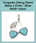 Silver-tone 26 x 37mm cherry charm with two turquoise-coloured heart stones and a leaf