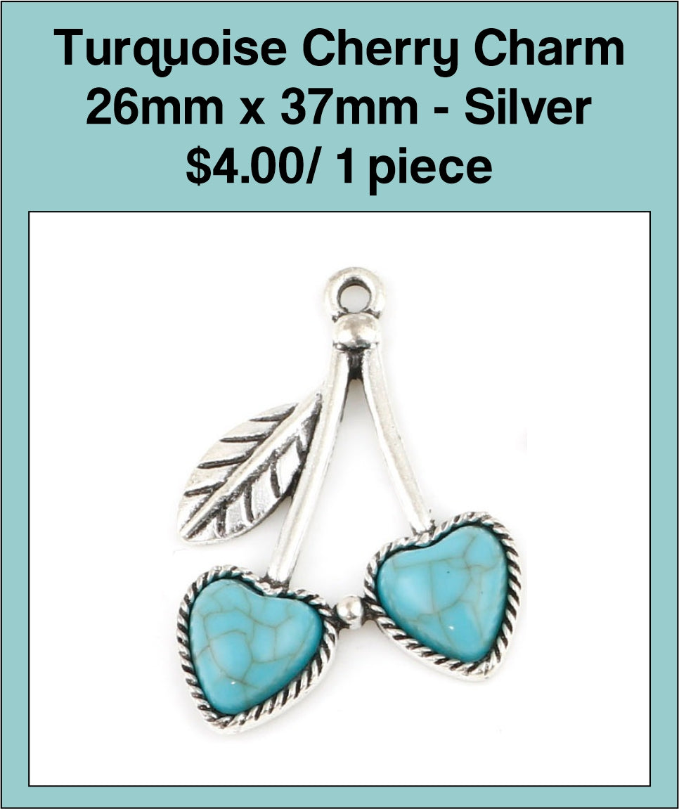 Silver-tone 26 x 37mm cherry charm with two turquoise-coloured heart stones and a leaf