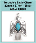 Silver-tone 22 x 38mm eagle charm with spread wings and a turquoise-coloured oval stone