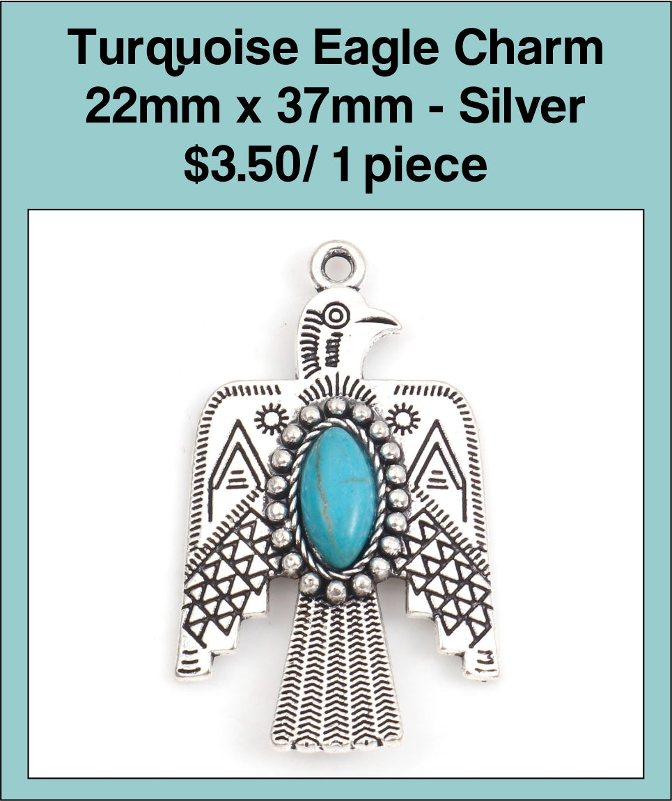 Silver-tone 22 x 38mm eagle charm with spread wings and a turquoise-coloured oval stone