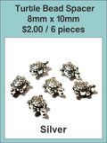 Silver-tone 8 x 10mm turtle spacer beads on a labelled product card