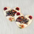 Pair of 37mm resin heart cabochons (cabs) in cream with a patterned turtle, red roses and orange flowers