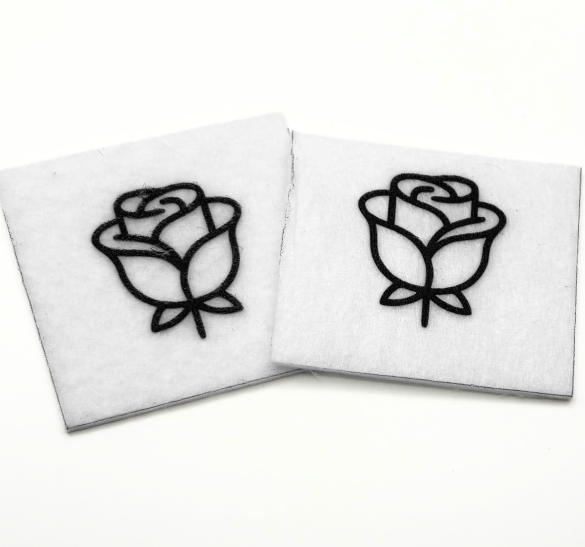 Two beading patterns printed in black on stiff white pellon squares, showing a rose with leaves