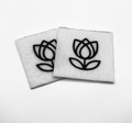 Two beading patterns printed in black on stiff white pellon squares, showing a tulip with layered petals