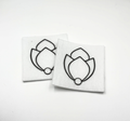 Two beading patterns printed in black on stiff white pellon squares, showing a tulip bud with a pearl