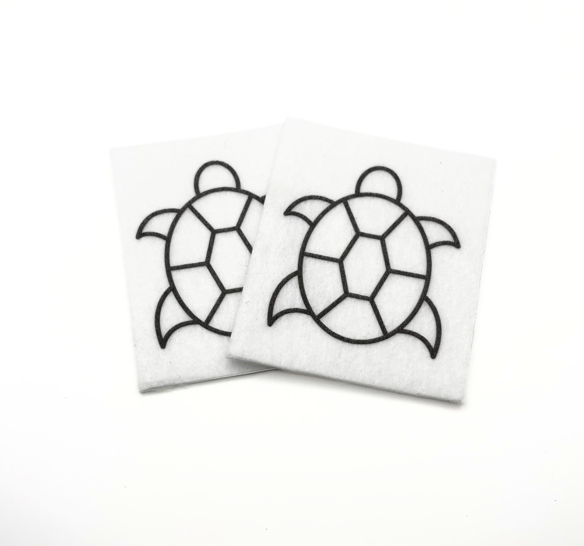 Two beading patterns printed in black on stiff white pellon squares, showing a sea turtle