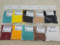 Ten 25g bags of Preciosa 11/0 seed beads in Wild Western colours: turquoise, yellow, browns, black, red, orange, white