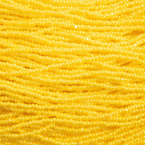 Close-up of strung Preciosa 13/0 true cut charlotte beads in opaque yellow with a luster finish
