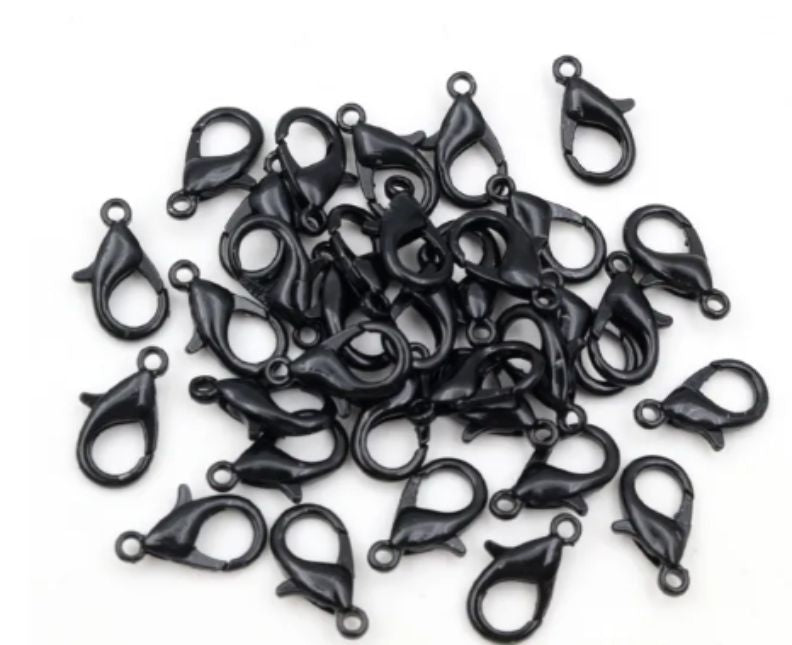 Pile of black 6 x 12mm lobster clasps with trigger openings, on a white background