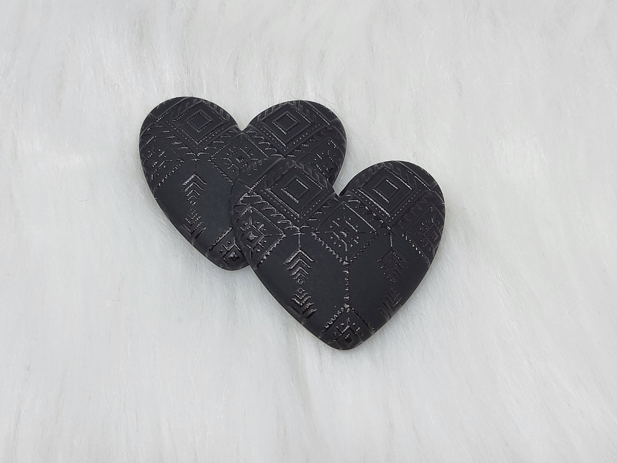 Pair of 37mm resin heart cabochons (cabs) in matte black with an embossed geometric pattern