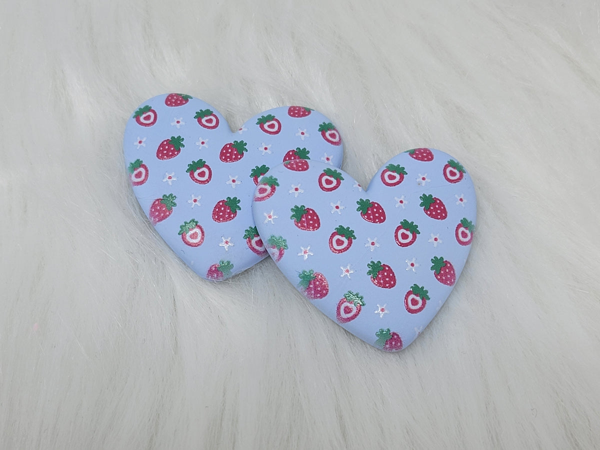 Pair of 37mm resin heart cabochons (cabs) in light blue with a red strawberry and white flower pattern