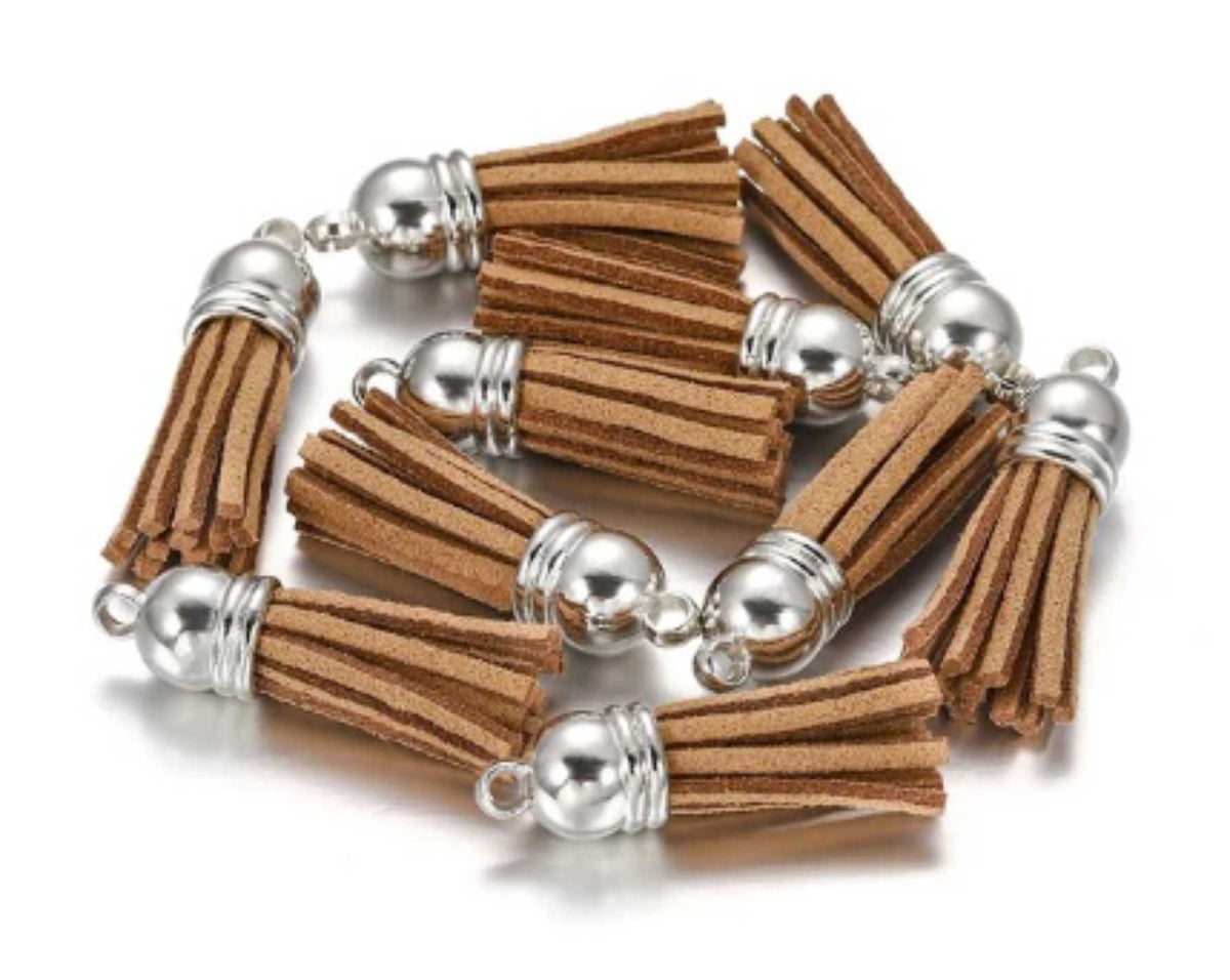 Pile of 38mm brown leather fringe tassels with silver-tone caps and loops