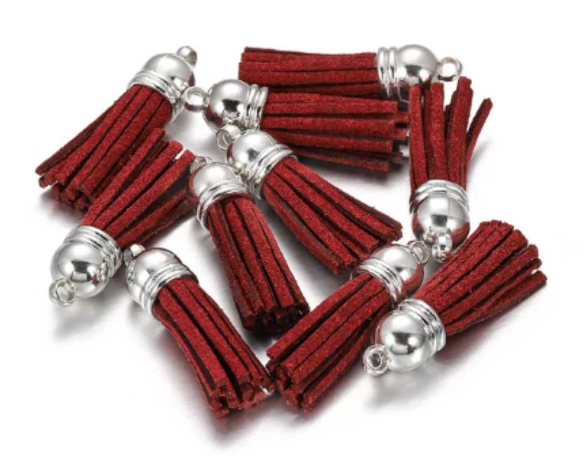 Pile of 38mm burgundy leather fringe tassels with silver-tone caps and loops