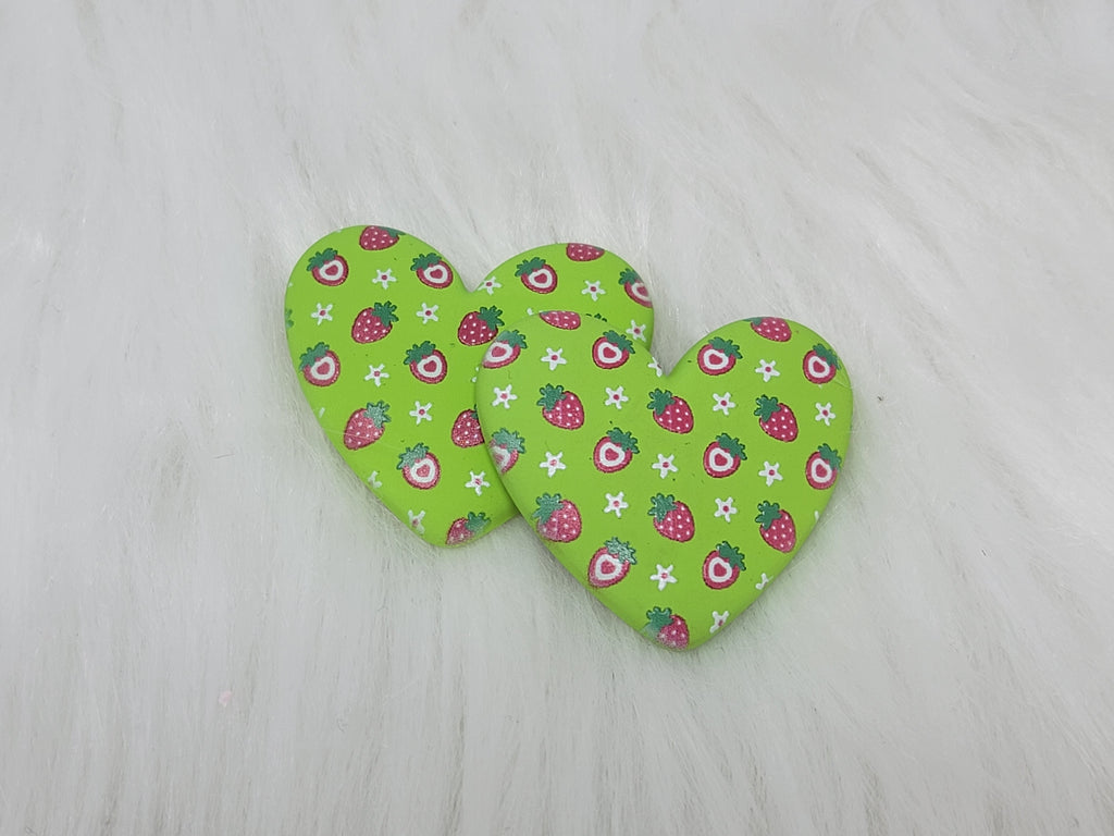 Pair of 37mm resin heart cabochons (cabs) in lime green with a red strawberry and white flower pattern