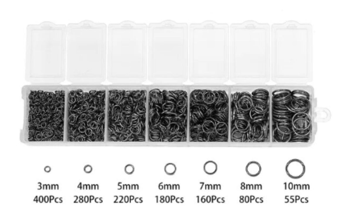 Clear divided case of gunmetal jump rings in seven sizes from 3mm to 10mm, with size labels