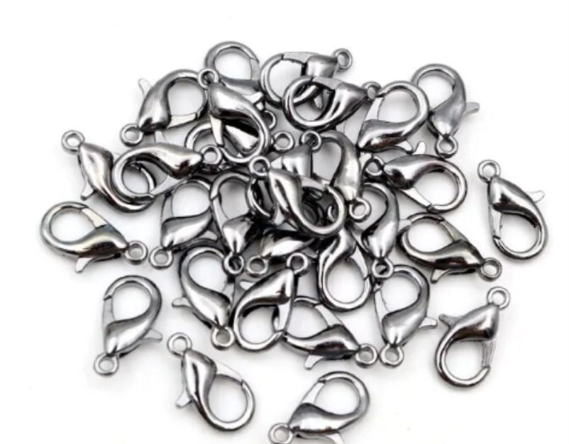 Pile of gunmetal 6 x 12mm lobster clasps with trigger openings, on a white background