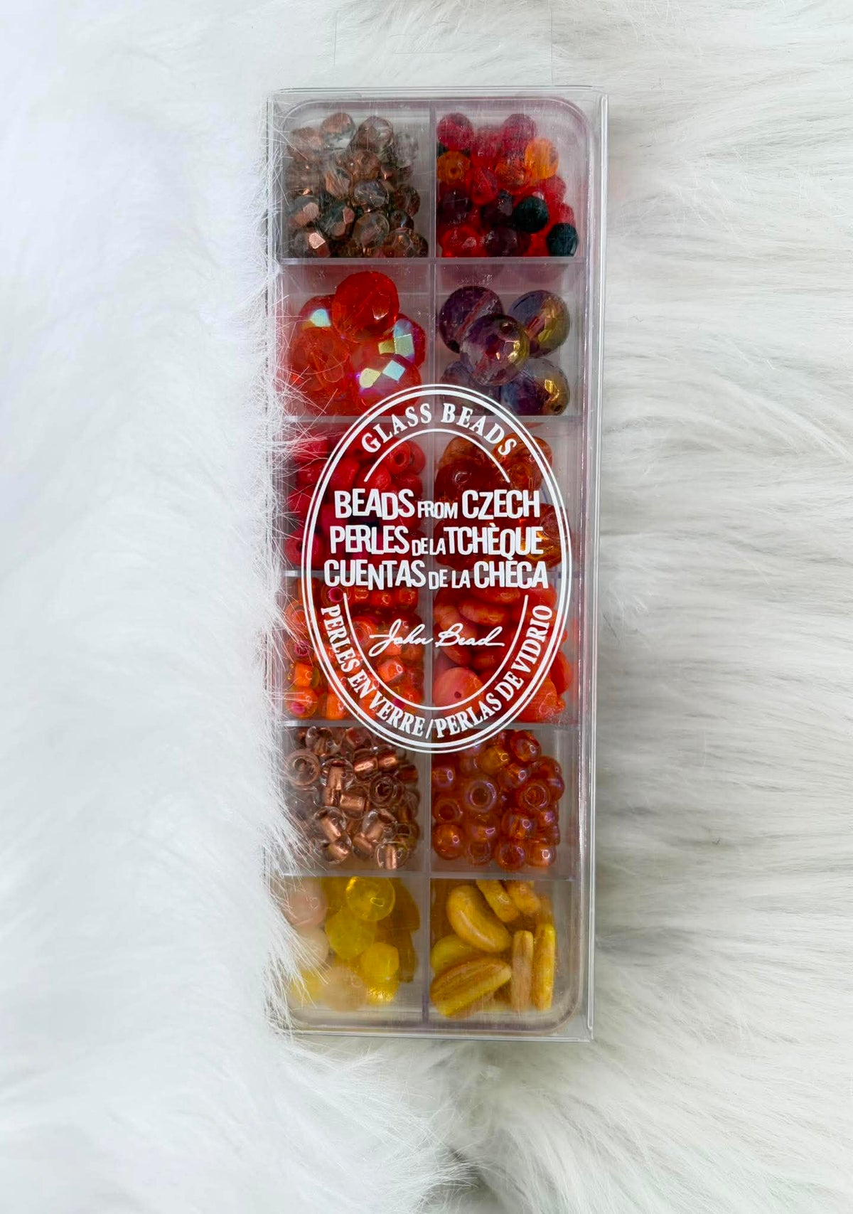 Divided case of assorted Czech glass beads, Capeverdi Senset, in reds, oranges and amber