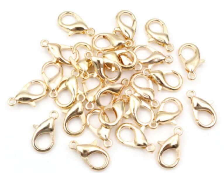 Pile of KC Gold 6 x 12mm lobster clasps with trigger openings, on a white background