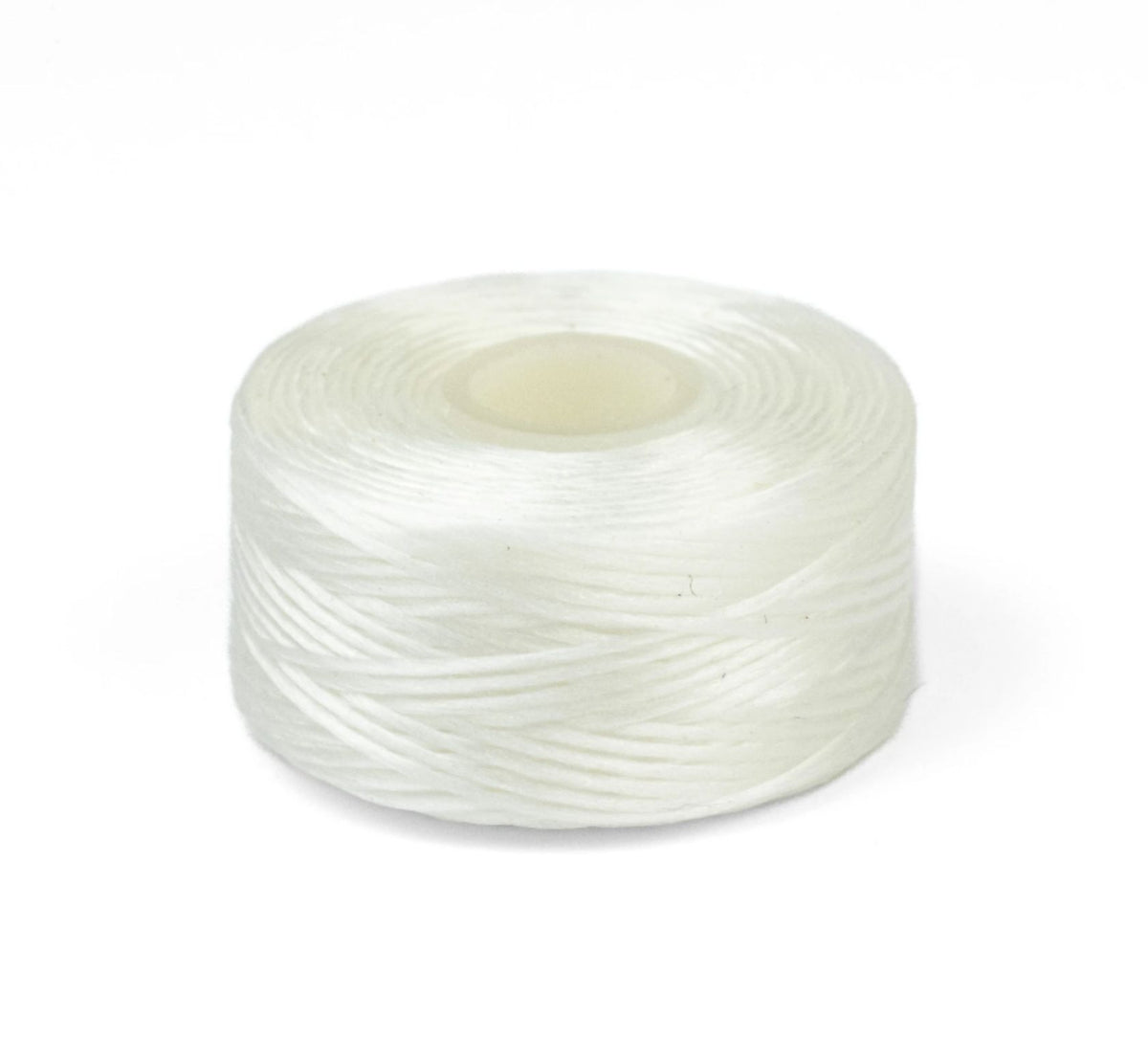 Large clear spool of white Nymo thread lying on its side on a white background