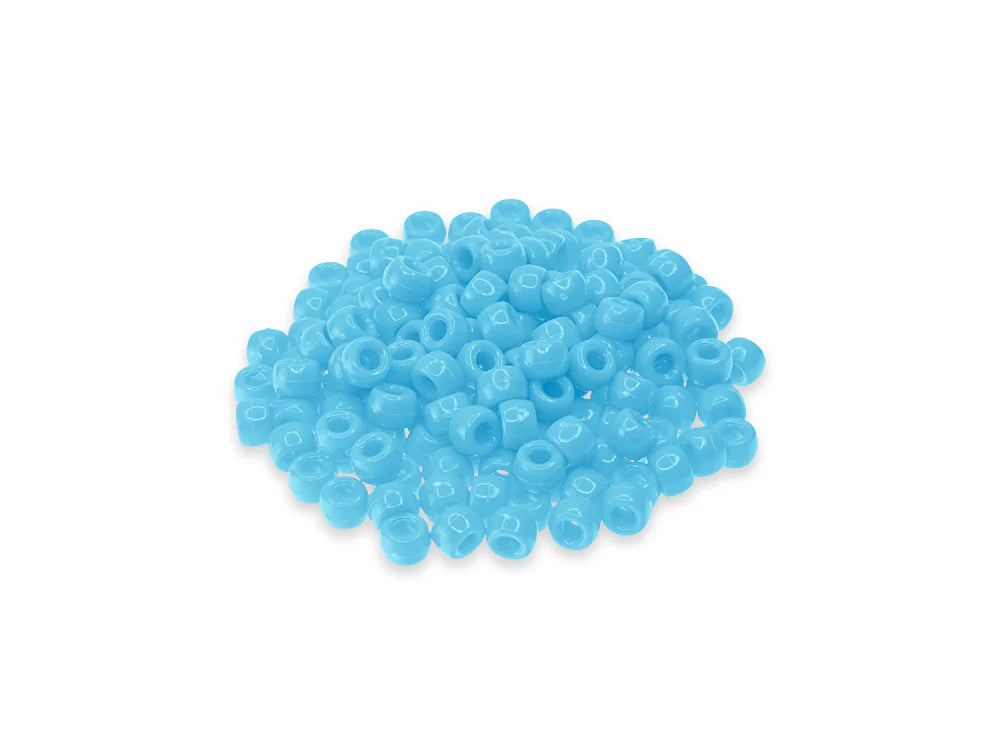 Pile of 6 x 9mm plastic pony beads in light blue on a white background