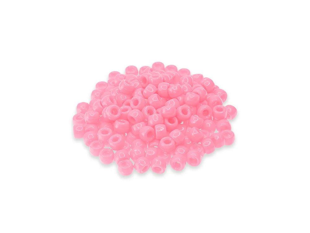 Pile of 6 x 9mm plastic pony beads in light pink on a white background