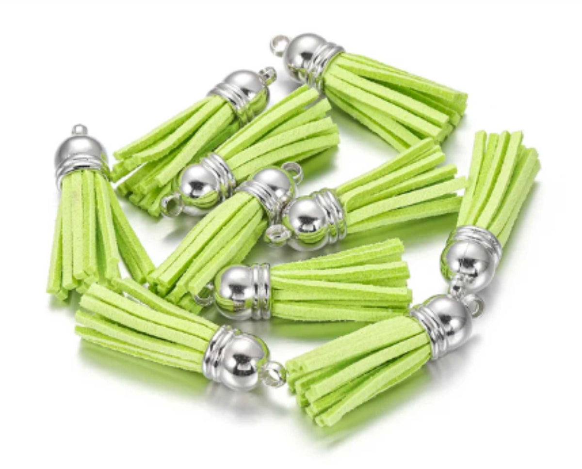 Pile of 38mm lime leather fringe tassels with silver-tone caps and loops