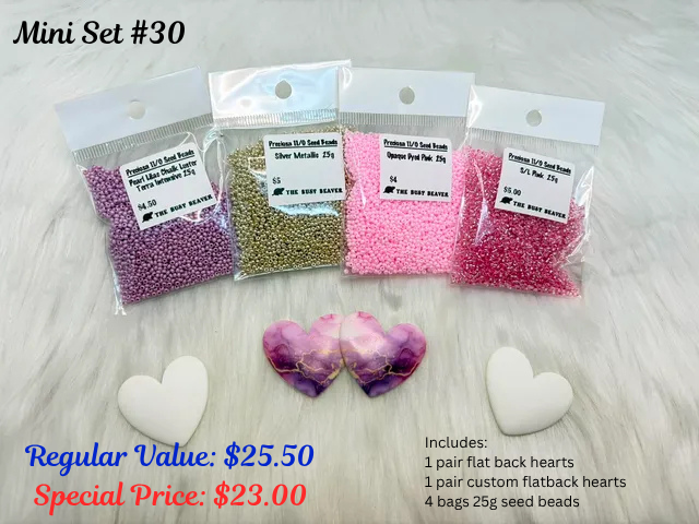 Mini set #30: white hearts, a pair of purple hearts and four bags of mauve, gold and pink seed beads