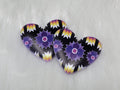 Pair of 37mm resin heart cabochons (cabs) in black with purple star flowers and rainbow zigzag accents