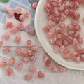 Bowl of 10 x 12mm pink swirl heart acrylic beads with a marbled clear finish