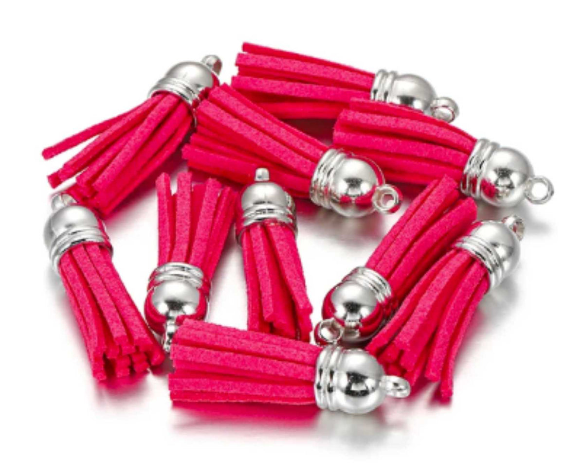 Pile of 38mm pink leather fringe tassels with silver-tone caps and loops