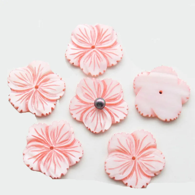 Carved pink mother of pearl flower pendants, 28mm, with a dark bead centre