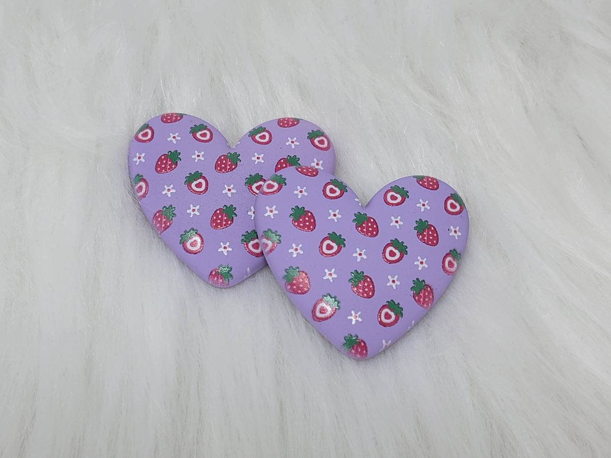 Pair of 37mm resin heart cabochons (cabs) in lilac with a red strawberry and white flower pattern
