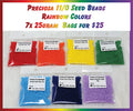 Seven 25g bags of Preciosa 11/0 seed beads in rainbow colours: red, orange, yellow, green, light blue, navy and purple