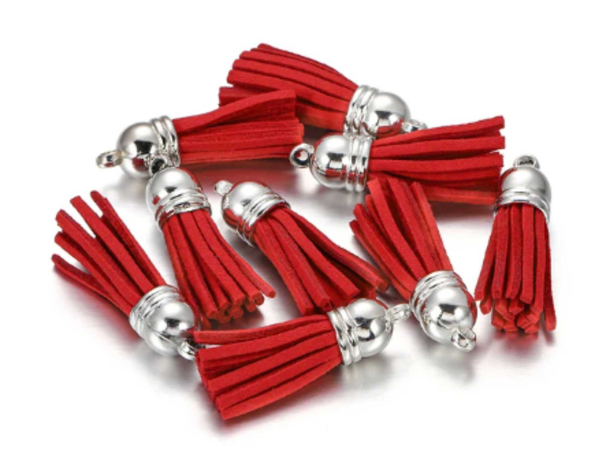 Pile of 38mm red leather fringe tassels with silver-tone caps and loops