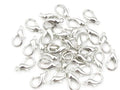 Pile of rhodium 6 x 12mm lobster clasps with trigger openings, on a white background