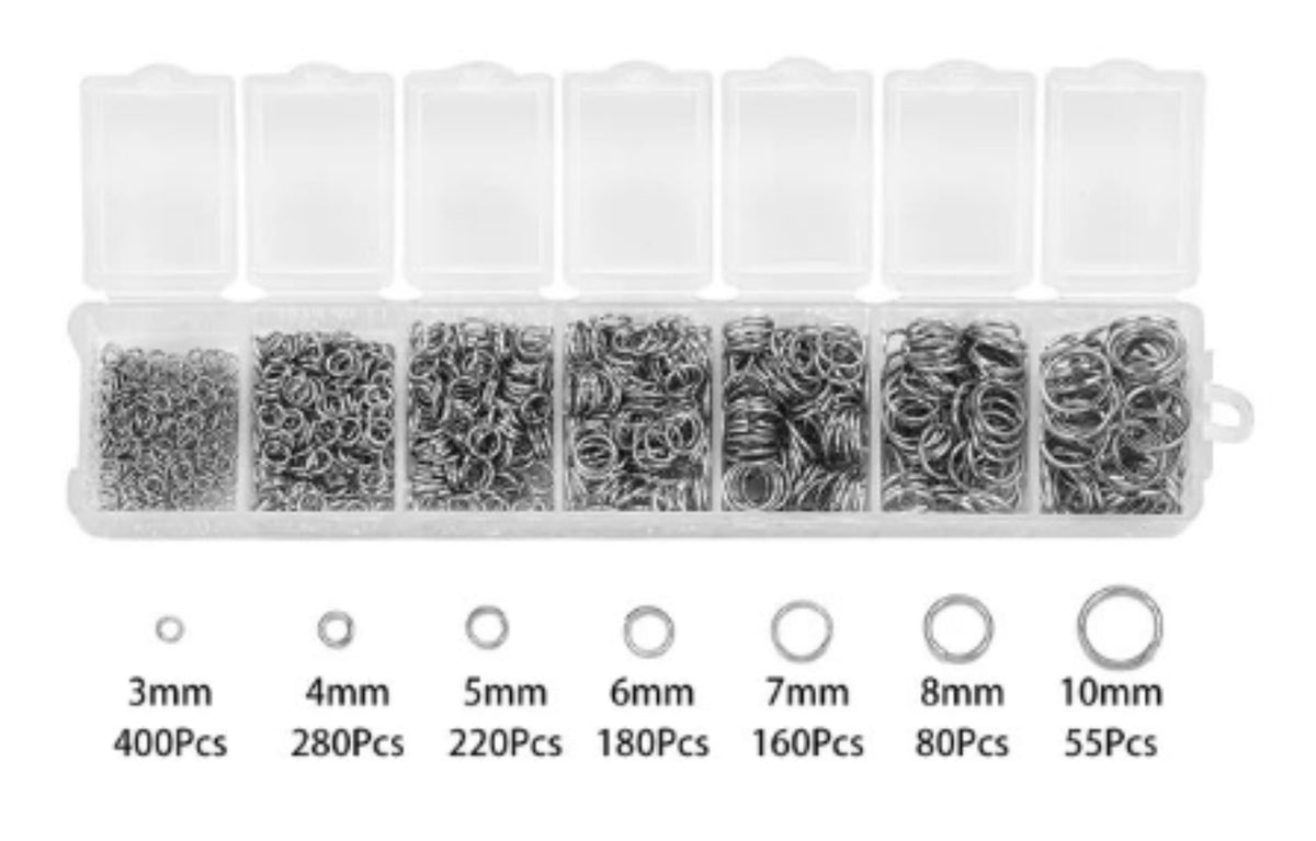 Clear divided case of rhodium jump rings in seven sizes from 3mm to 10mm, with size labels
